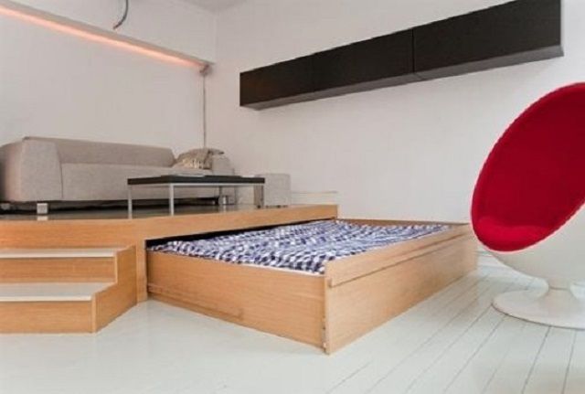 Кровать на дневное время задвигается в подиум, который, в свою очередь, служит своеобразной "изюминкой" интерьера гостиной